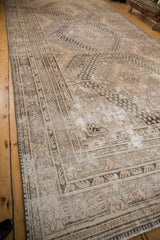 Textured geometric patterns with distressed field and visible foundation on a Khotan rug.