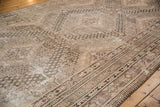 Detailed distressed Khotan rug showing pale rose blush motifs, oxidized silver tones, and soft worn texture.