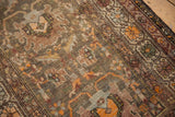 Detail of the antique Northwest Persian runner's field, showing intricate floral arrangements, tangerine palmette, and wear.