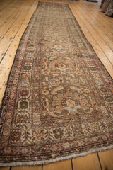 Corner and fringe of antique Northwest Persian runner, intricate floral border, and time-softened hues.