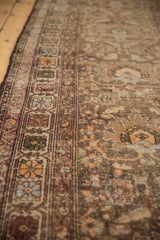 Antique Northwest Persian runner border featuring floral medallions in sand, green, and tangerine.