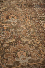 Antique Northwest Persian runner's intricate floral field, showcasing worn pile and muted hues.