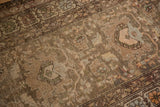 Antique Northwest Persian rug with faded sand palmette motif and field blossoms, showing wear.
