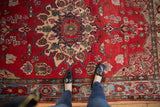 Vintage Northwest Persian rug detail: cherry red field with aqua border and trefoil floral blossoms.
