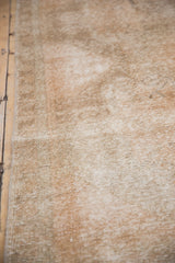 Distressed Oushak rug with even wear showing beige and ivory foundation.