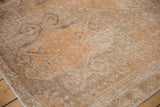Distressed Oushak rug texture with even wear, exposed foundation, apricot, and pale charcoal.