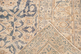 Folded corner of the distressed Sparta carpet showing foundation and faded floral pattern.