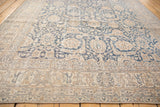 Distressed denim blue and ivory floral patterns with textured wear on a vintage Sparta rug.