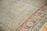 Distressed vintage Tabriz carpet showing worn aqua field and cochineal turtle samovar border.