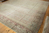 Distressed Tabriz rug featuring classic turtle samovar border with cochineal and aqua green.