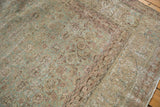 Distressed vintage Tabriz carpet showing mostly even wear, visible foundation, and muted aqua, ivory colors.