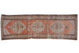 Distressed vintage Oushak runner with peach and ivory abrashed field, geometric medallions.