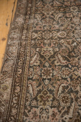 Distressed texture of the vintage Malayer rug, showing Herati motifs and muted brown, rose, ivory.