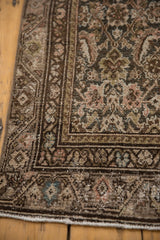 Distressed vintage Malayer runner corner, Herati motif, foundation visible, charcoal, dusty rose hues.