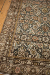 Vintage Malayer rug with worn Herati motif, charcoal field, and layered borders.