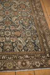 Distressed Persian Malayer rug detail: Herati motif in time-softened charcoal, rose, and sky blue hues.