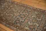 Distressed pile of a vintage Malayer runner showing allover Herati pattern in charcoal, dusty rose, and sky blue.
