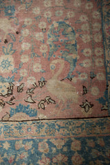 Distressed vintage Tabriz carpet detail: blush field, ocean blue millefleur, swan motif, and ornate border.