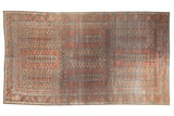 Vintage distressed Belouch carpet with a paneled tree of life design in terra cotta, powder blue, and brown.