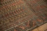 Angled view of the distressed texture on a Belouch rug's tree of life panels.