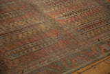 Angled view highlighting the germinating tree of life pattern and distressed texture of the Belouch carpet.