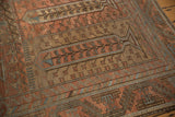 Paneled tree motifs in time-softened terra cotta and blue on a distressed Belouch carpet.