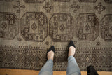 Vintage distressed Ersari carpet, repeating floral gul motifs, oxidized silver abrashes, and feet.