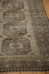 Ersari carpet detail: distressed texture, even wear, oxidized silver gul motifs, charcoal border.