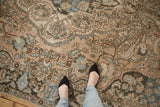 Distressed vintage Baktiari rug detail with low pile, visible foundation, palmettes, and blue florals.