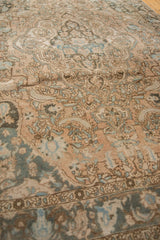 Distressed vintage Baktiari section reveals soft blue palmettes and vinery on faded ivory.