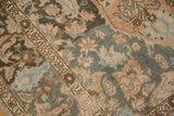 Distressed vintage Baktiari carpet detail, showing worn palmette and lotus motifs in dusty teal.