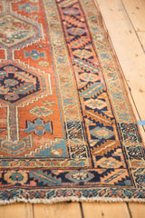 Vintage Persian Heriz rug runner fringe and geometric navy, brick red border.