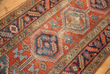 Primitive floral field, geometric navy blue medallion, and abrash on a vintage Heriz rug runner.