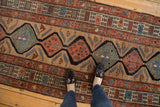 Antique Serab runner detail with alternating sand, mallard green, and madder red medallions.
