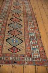 Detail of antique Serab runner shows interconnected geometric medallions, boteh motifs, and even wear.