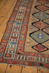 Antique Serab rug runner's red germinating flower border and camel field with boteh motifs.