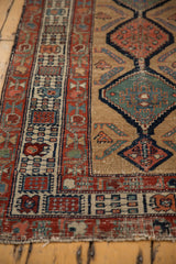 Antique Serab rug runner showing geometric borders, sand field motifs, and visible wear to knot heads.