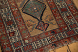 Serab runner corner, red and blue borders, camel field, green medallion, exposed foundation.