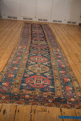 Hand-knotted vintage Malayer runner, displaying repeating geometric guls in navy, red, saffron.