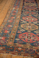 Malayer runner's geometric guls with navy blue, madder red, and saffron gold tones.