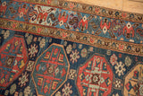 Vintage Malayer runner's geometric guls and starburst motifs in navy, madder red, and sky blue.