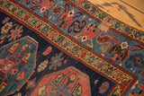 Vintage Malayer runner detail: navy and sky blue geometric patterns, red guls, localized foundation showing.