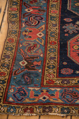 Sky blue border and navy field of a hand-knotted Malayer runner with madder red geometric motifs.