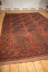 Low pile and even wear on cherry red geometric guls of the vintage Ersari carpet.