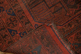 Vintage Ersari carpet with cherry red and navy geometric guls, low pile, worn fringe.