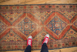 Antique Persian Mahal runner, madder red and sky blue diamond pattern, showing mostly even wear.