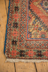 Antique Mahal rug corner, featuring madder red serrated motifs, sky blue side, and natural worn fringe.