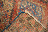 Hand-knotted foundation, secured blue edge, and ivory fringe of this antique Mahal rug.