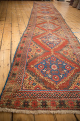 Fringed end of Antique Mahal runner, madder red, sky blue serrated patterns, mostly even wear.