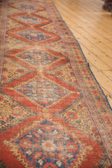 Antique Mahal runner with repeating diamond pattern, madder red, sky blue, and even wear.